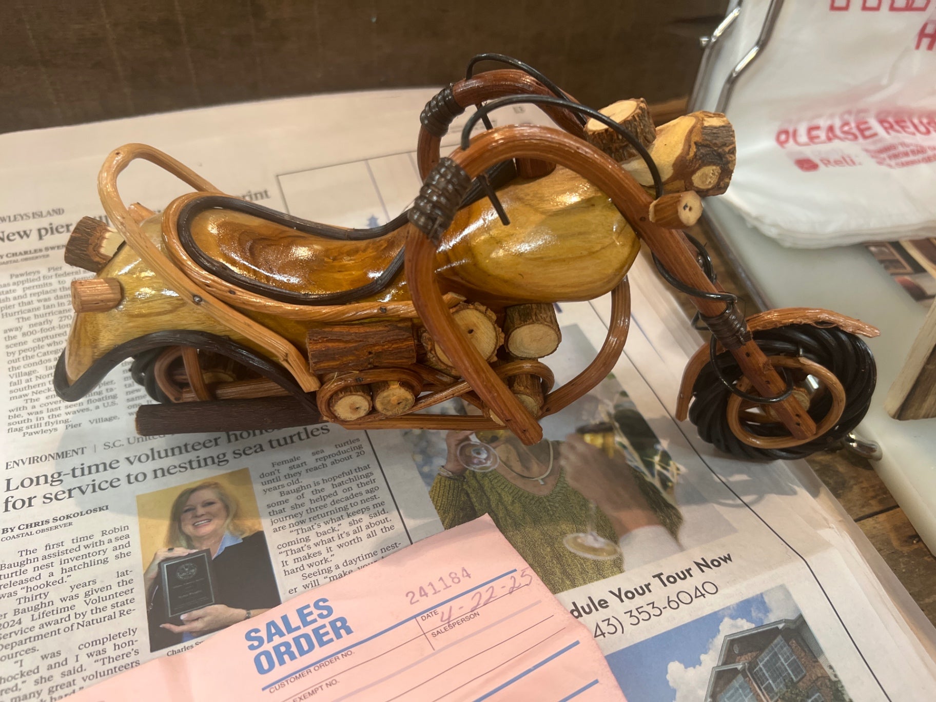 Decorative motorcycle sculpture Various shades of brown, black and beige Wood and possibly some metal components