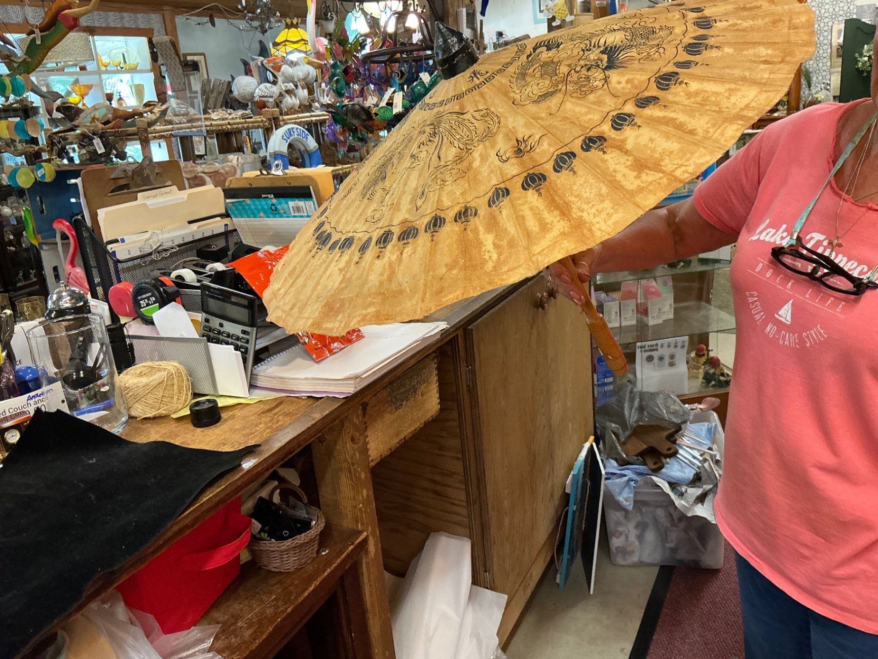 Umbrella Natural wood tone with black design Wood and possibly fabric or paper for the canopy