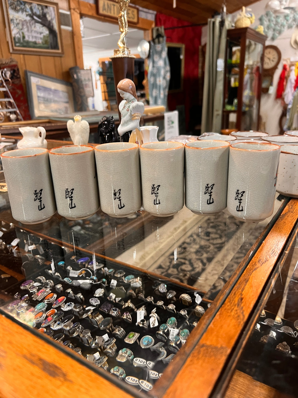Vintage Japanese sake cup set (6 cups) with crackle glaze and Kokeshi doll-style designs, signed on back