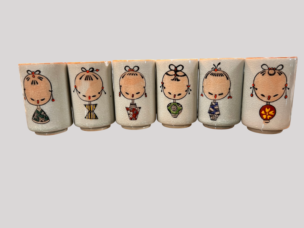 Vintage Japanese sake cup set (6 cups) with crackle glaze and Kokeshi doll-style designs, signed on back