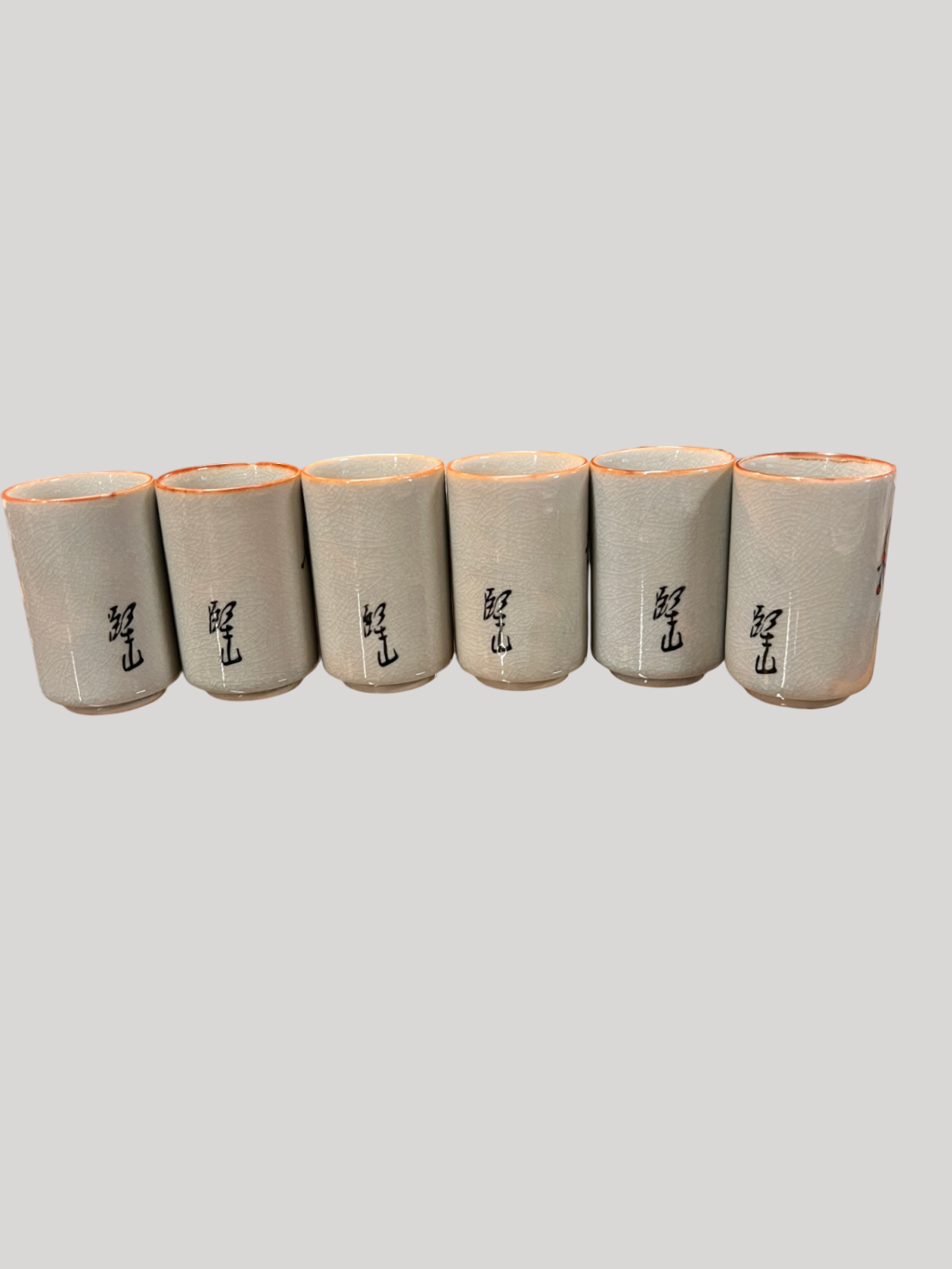 Vintage Japanese sake cup set (6 cups) with crackle glaze and Kokeshi doll-style designs, signed on back