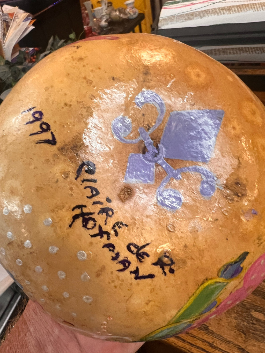 Hand-painted dried gourd ornament/lantern, signed Claire de Hoffman, dated 1997. Features angelic musicians and decorative motifs.