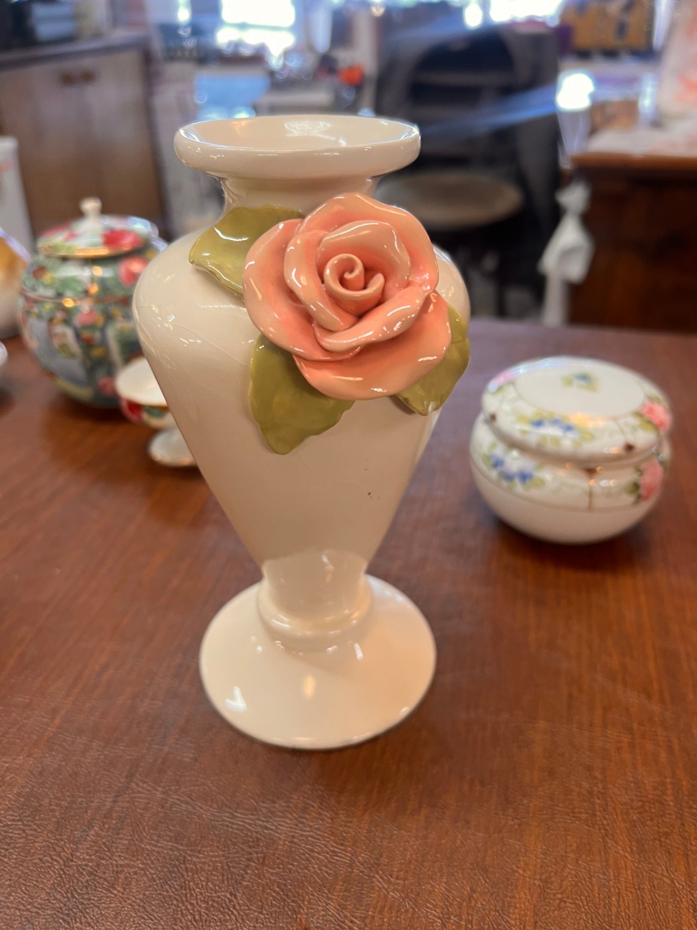 Vintage ceramic bud vase with a raised pink rose and green leaves design. 