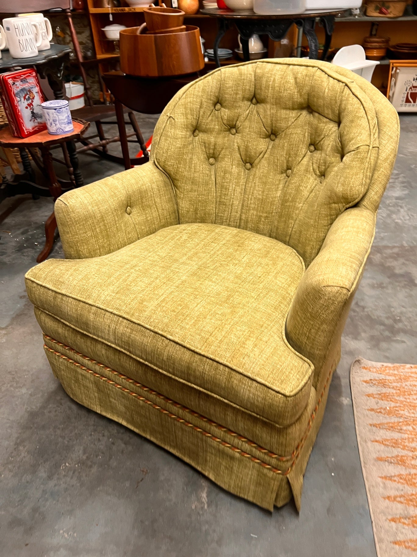 Woodmark Originals Swivel Rocker club chair in a moss green exterior with a gold crosshatch pattern