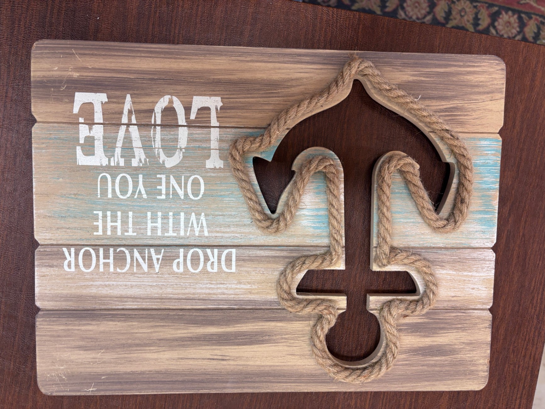 Wood wall sign featuring an anchor design and the phrase "Drop Anchor with the One You Love". 