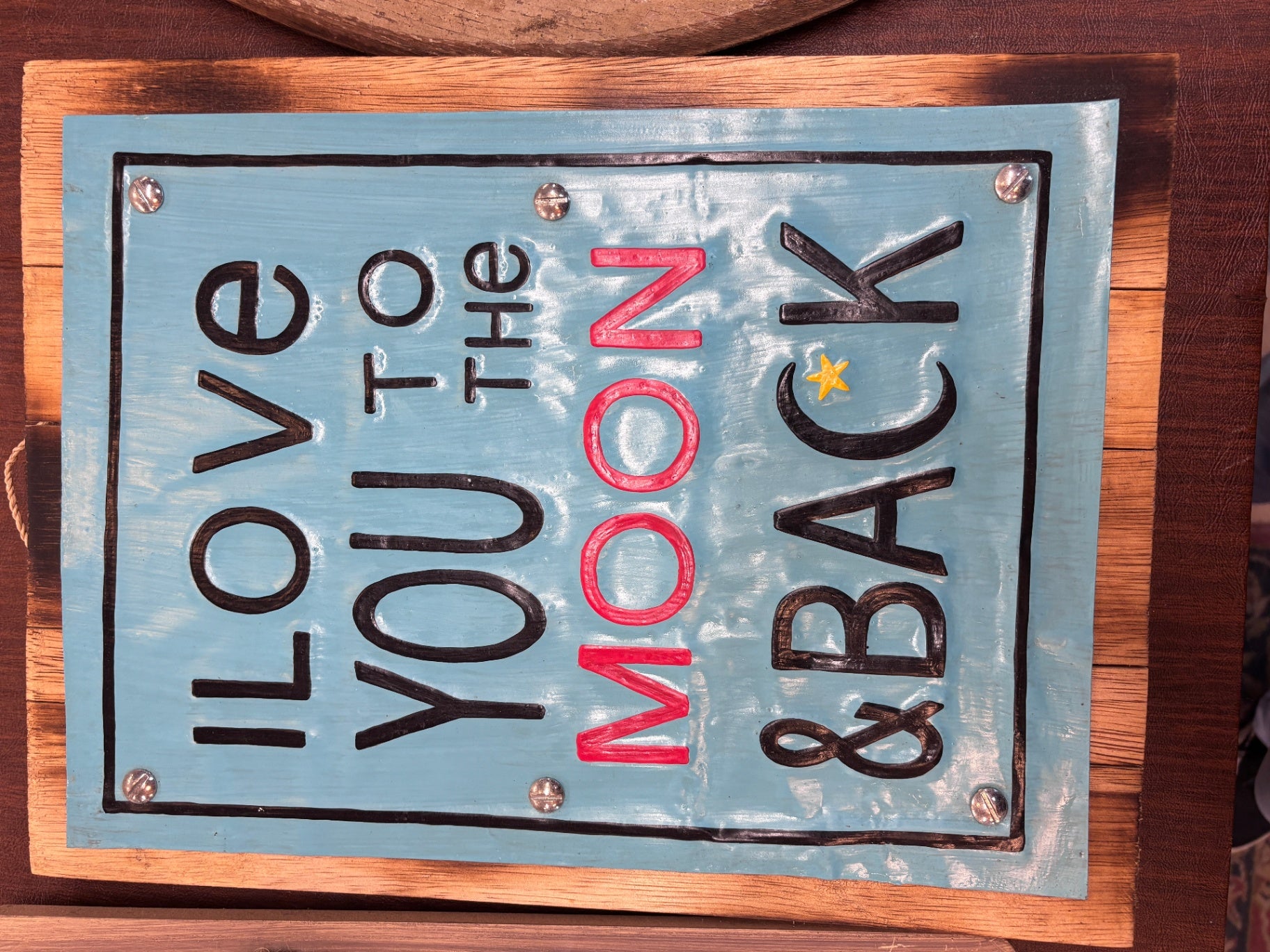 Wooden wall plaque e saying "I Love You To The Moon & Back". 