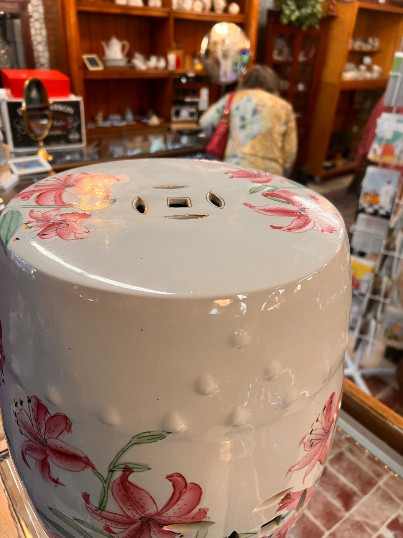 Hand-painted white porcelain garden seat, adorned with lilies.