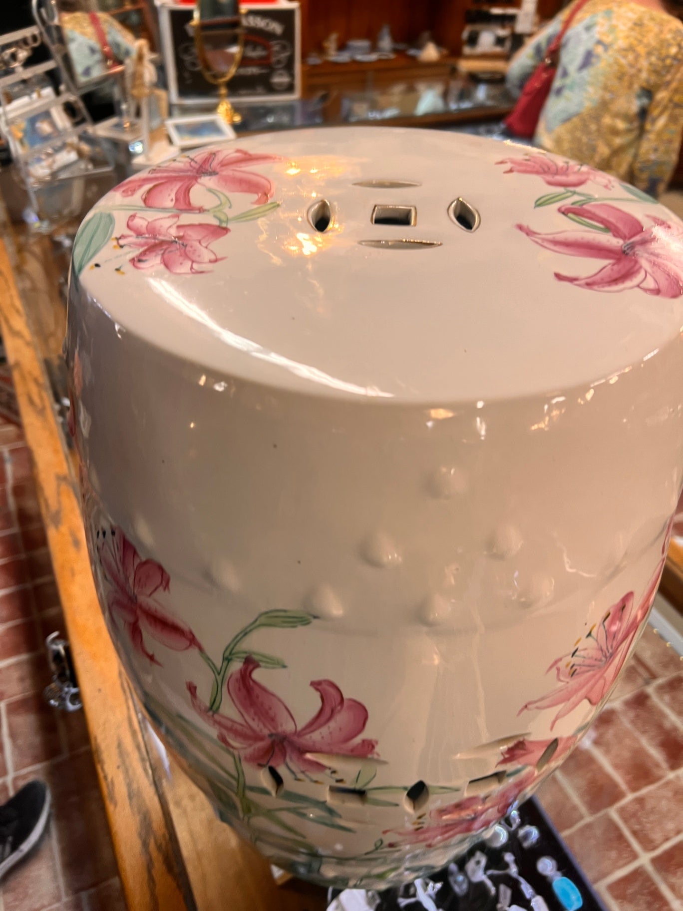 Hand-painted white porcelain garden seat, adorned with lilies.