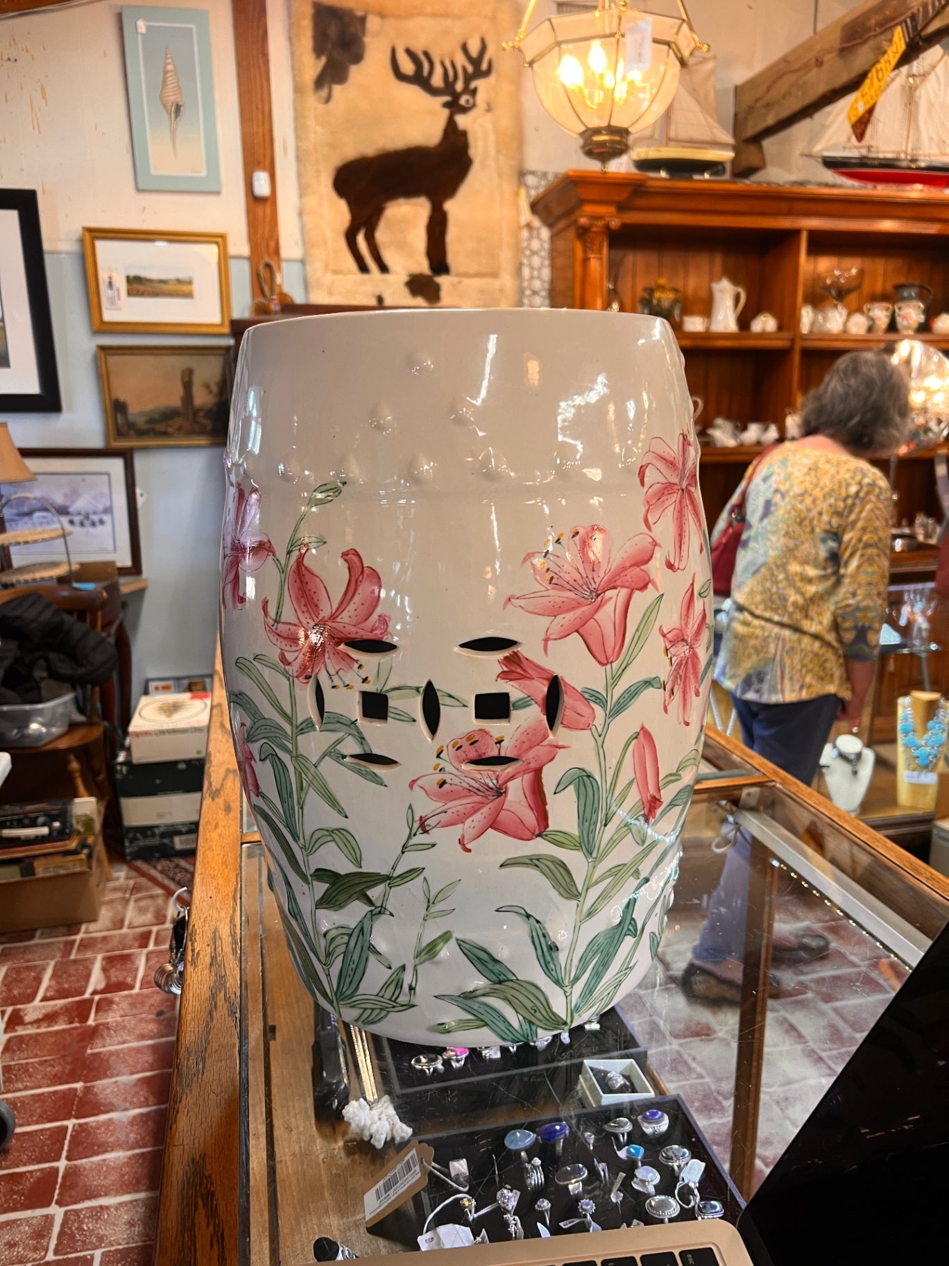 Hand-painted white porcelain garden seat, adorned with lilies.