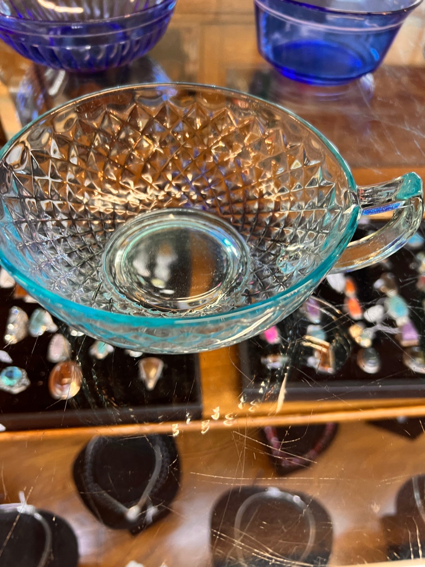 Transparent teal or light blue glass bowl with Handle