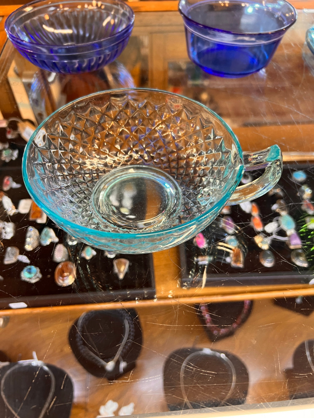 Transparent teal or light blue glass bowl with Handle