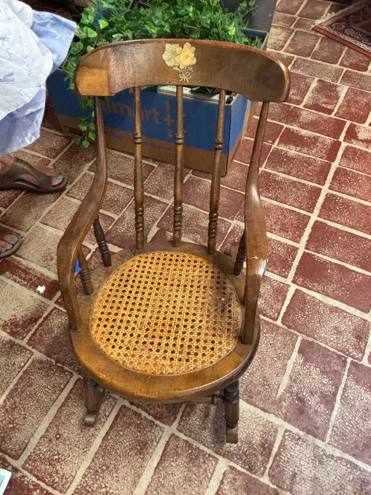 Antique wooden rocking chair featuring a woven cane seat 
