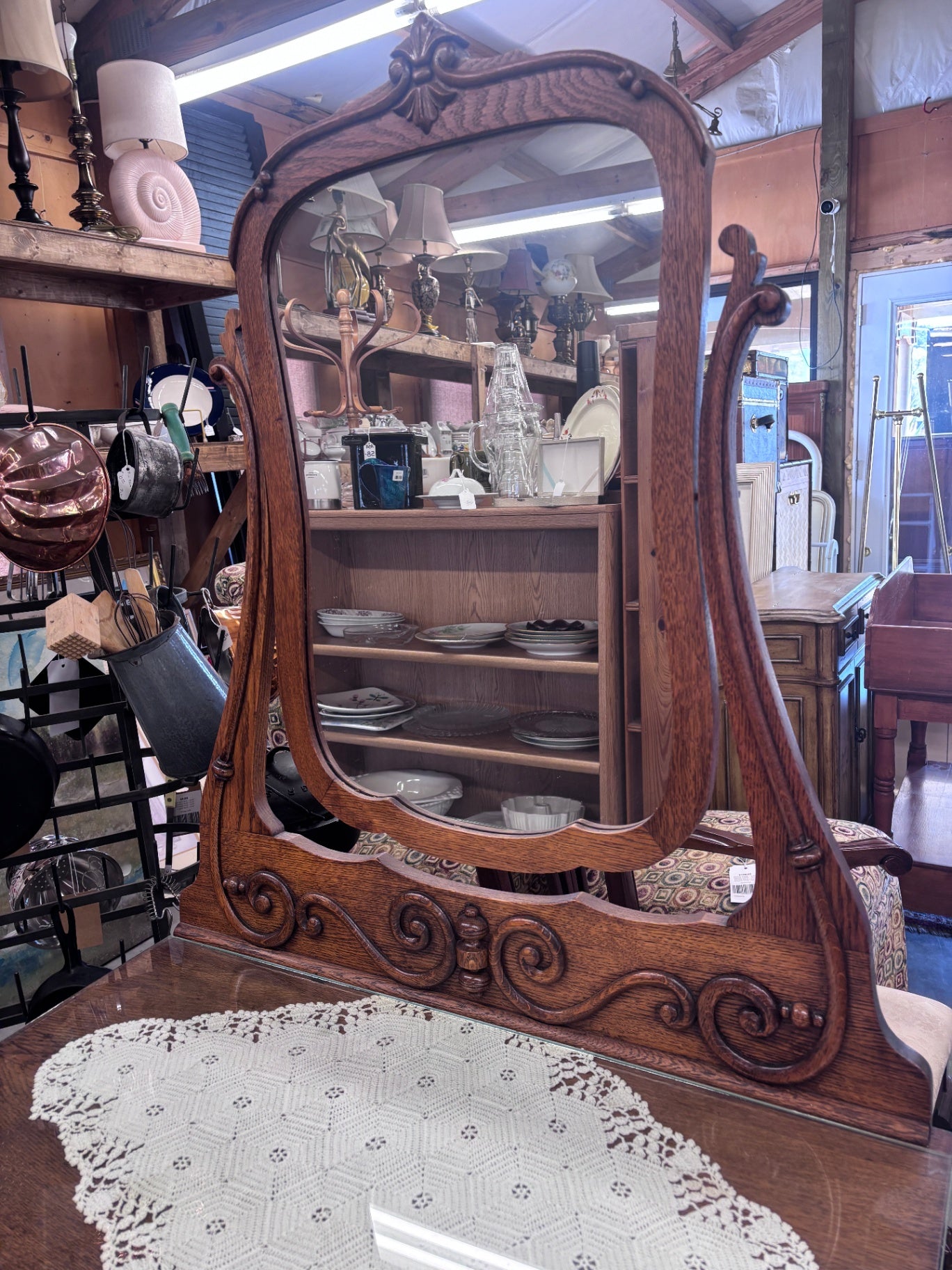 Victorian-style tiger oak vanity with a large, ornate beveled mirror