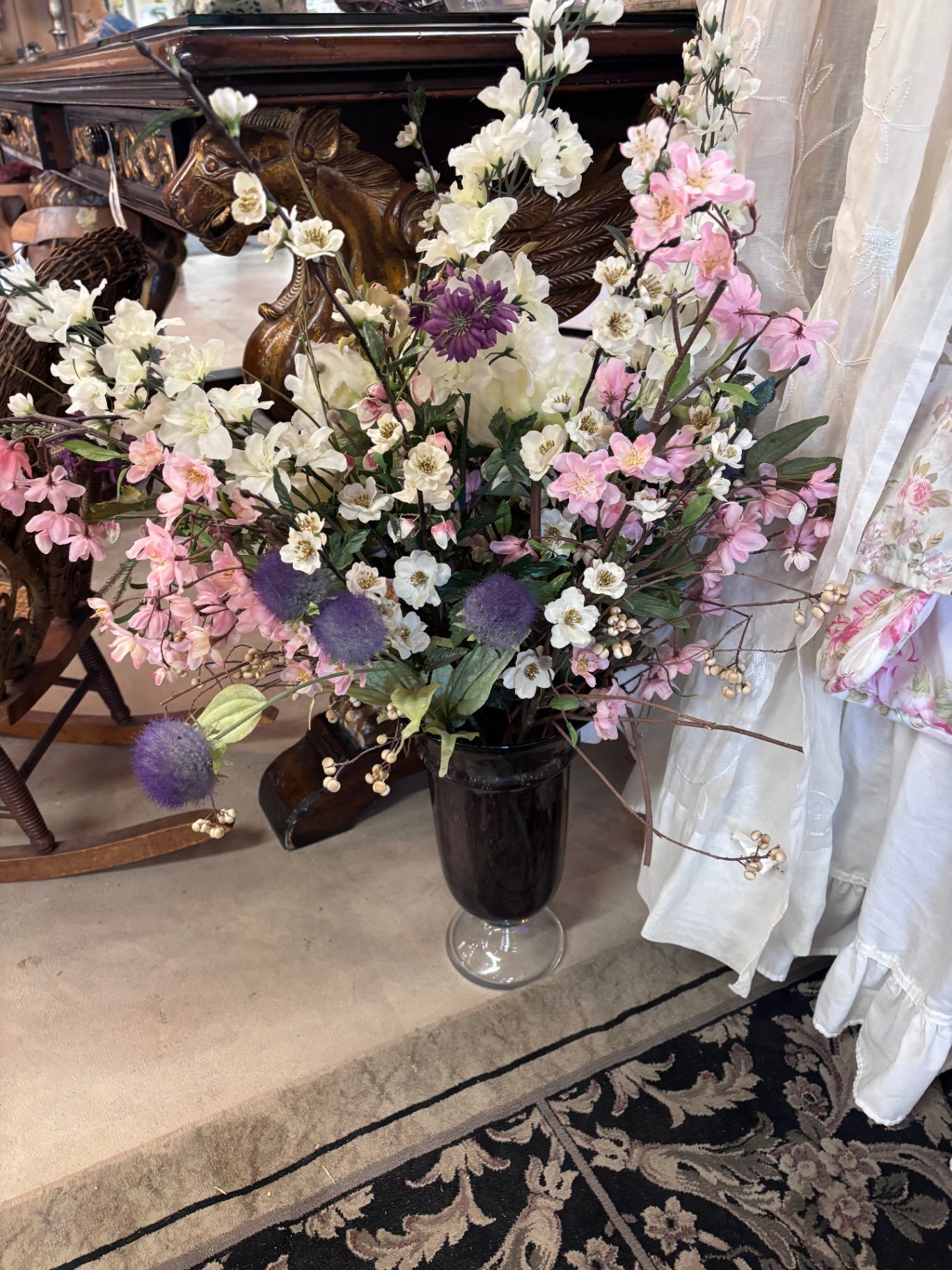Amethyst purple glass pedestal vase with flowers