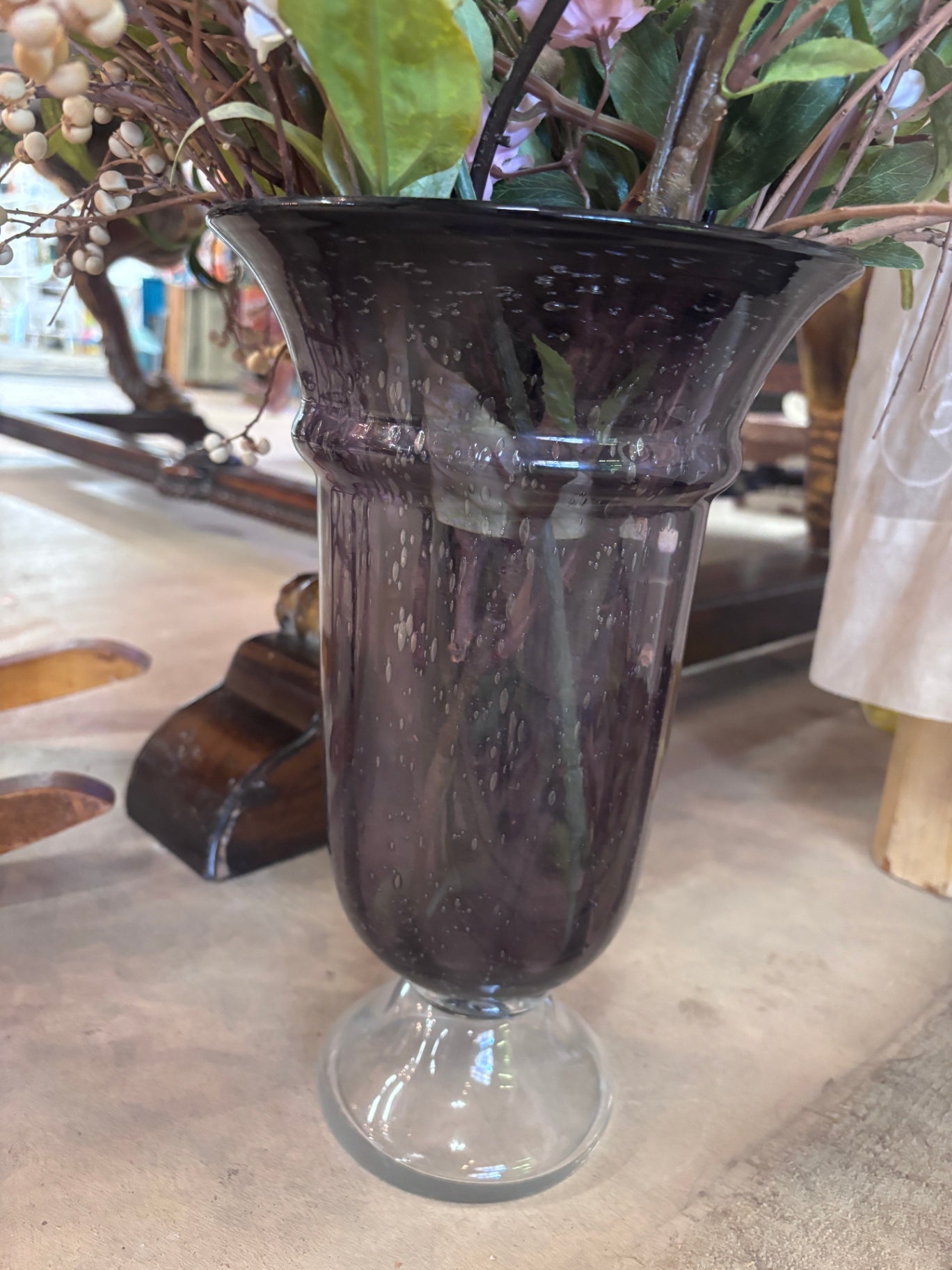 Amethyst purple glass pedestal vase with flowers