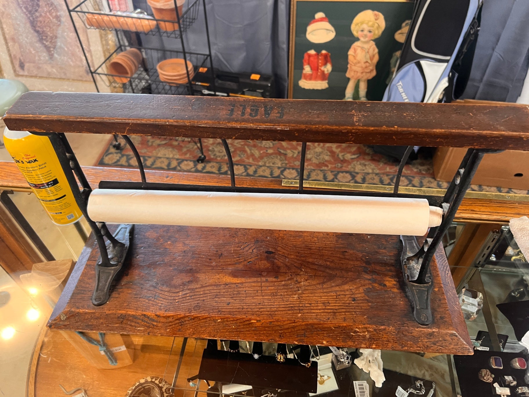This vintage item is an antique butcher paper dispenser and cutter, typically used in general stores or butcher shops during the early 20th century Eagle Millenry