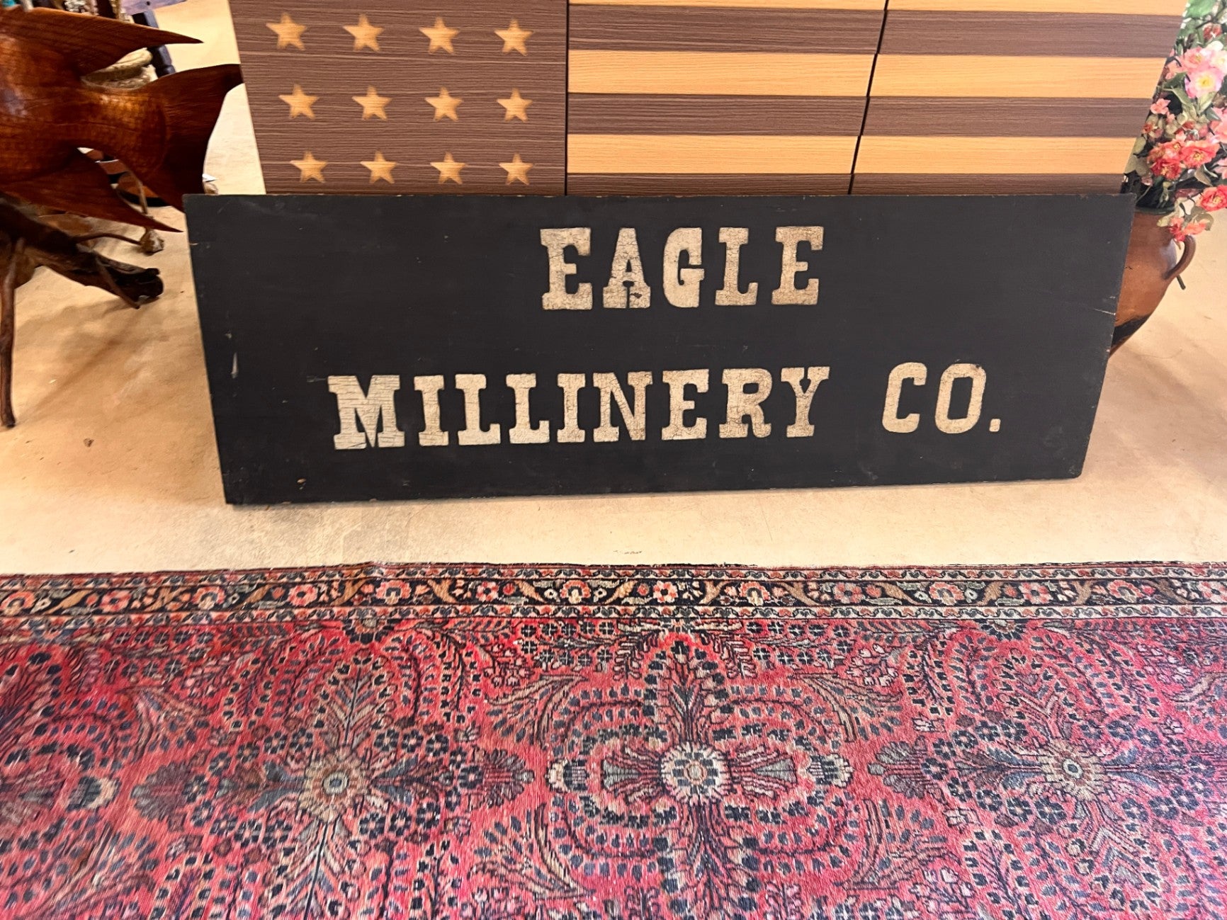 19th Century American Millinery Trade Sign “Eagle Millinery Co.” Hand Painted on Single Board Black Ground 60" x 20"