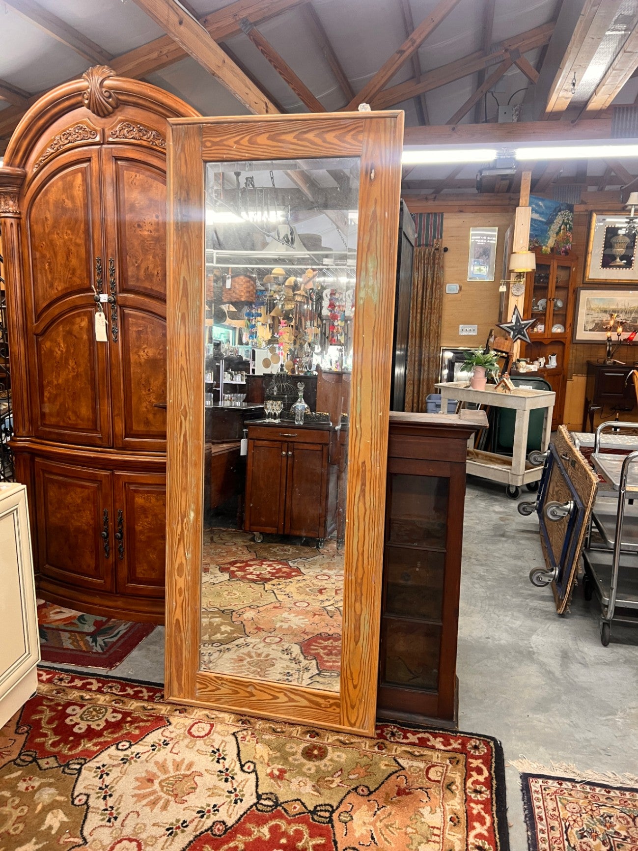rustic pine wood framed full-length floor mirror.