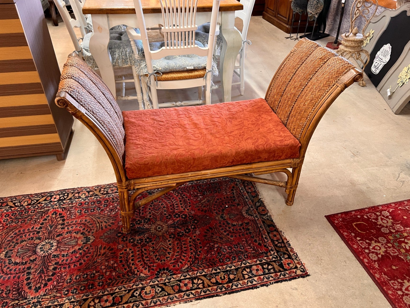 vintage rattan roll top arm bench with woven wicker and a cushion