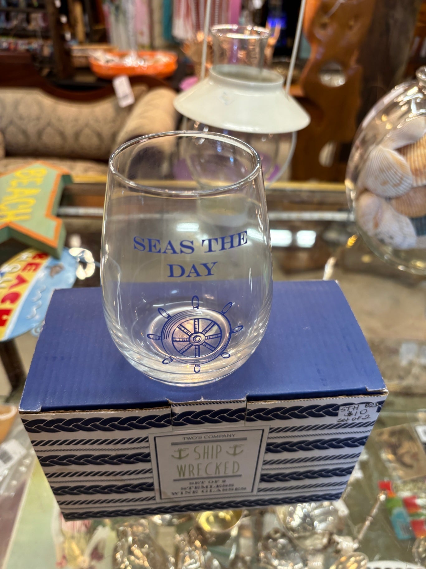 "Seas the Day" stemless wine glass features a blue nautical decal