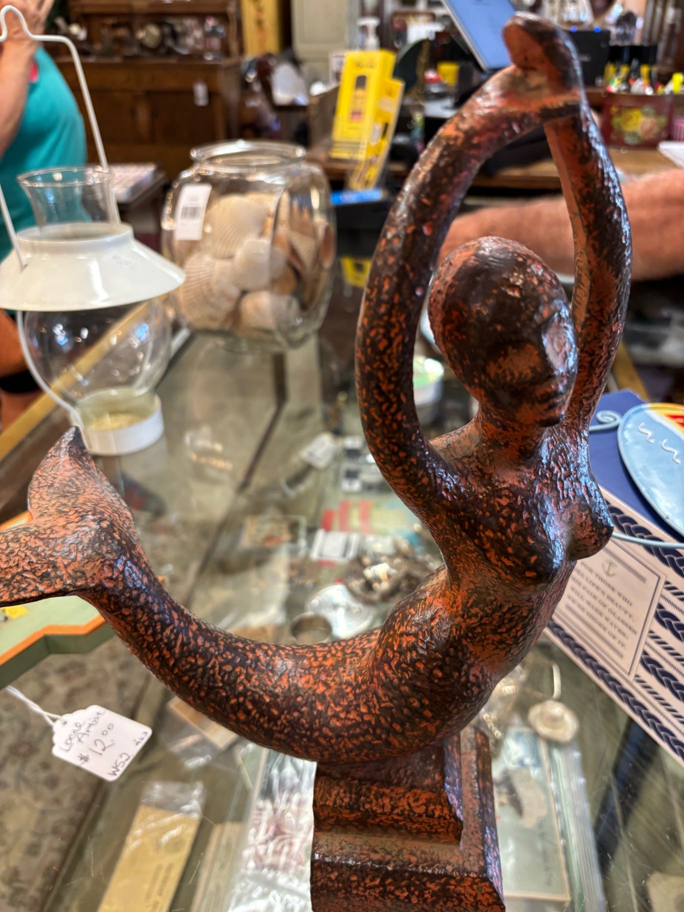 This cast iron mermaid sculpture resembles Verona-style fish bowl holders often finished in a rustic, brass-plated style.