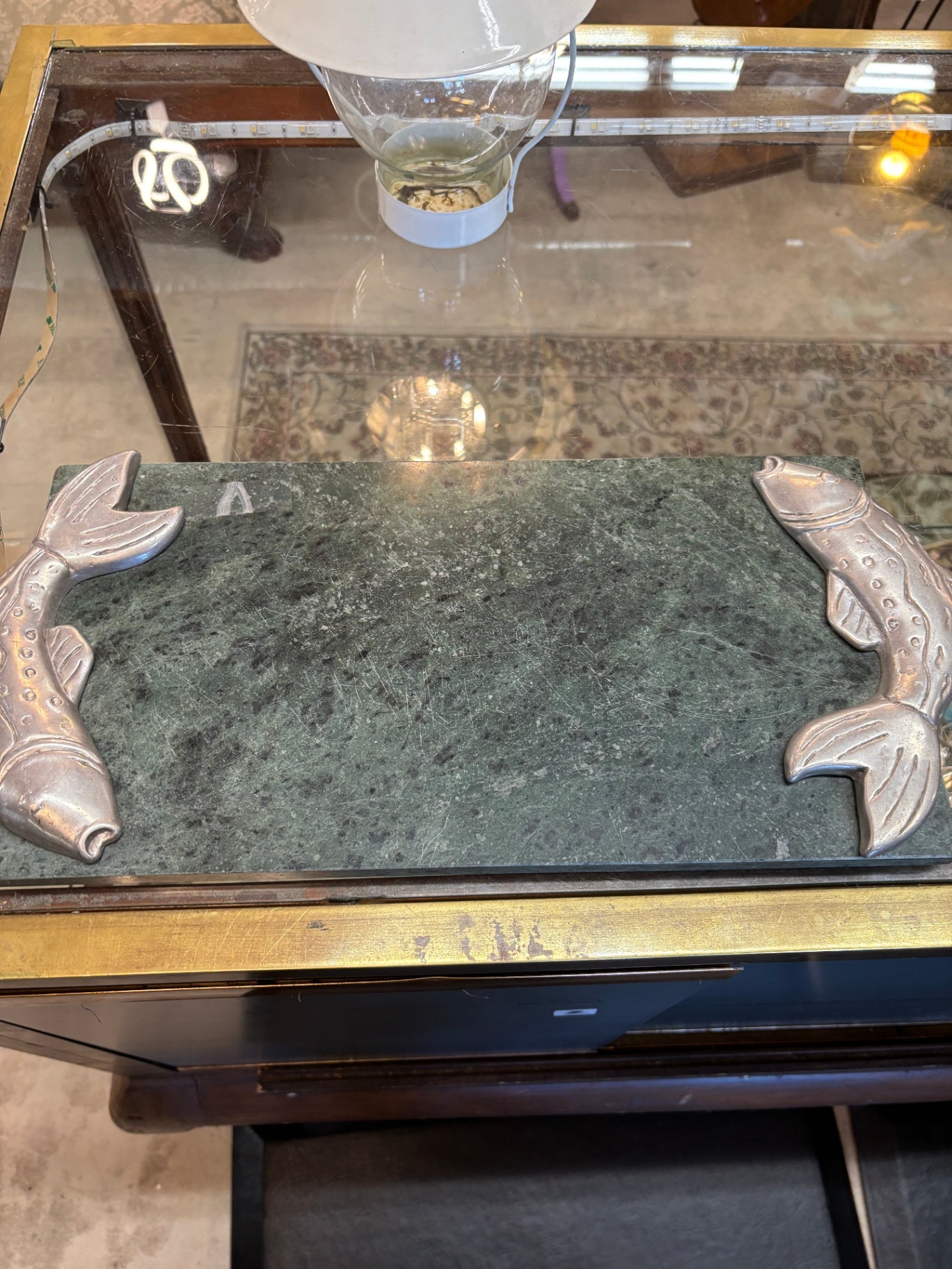 This vintage-style green marble serving tray features distinctive pewter fish-shaped handles.