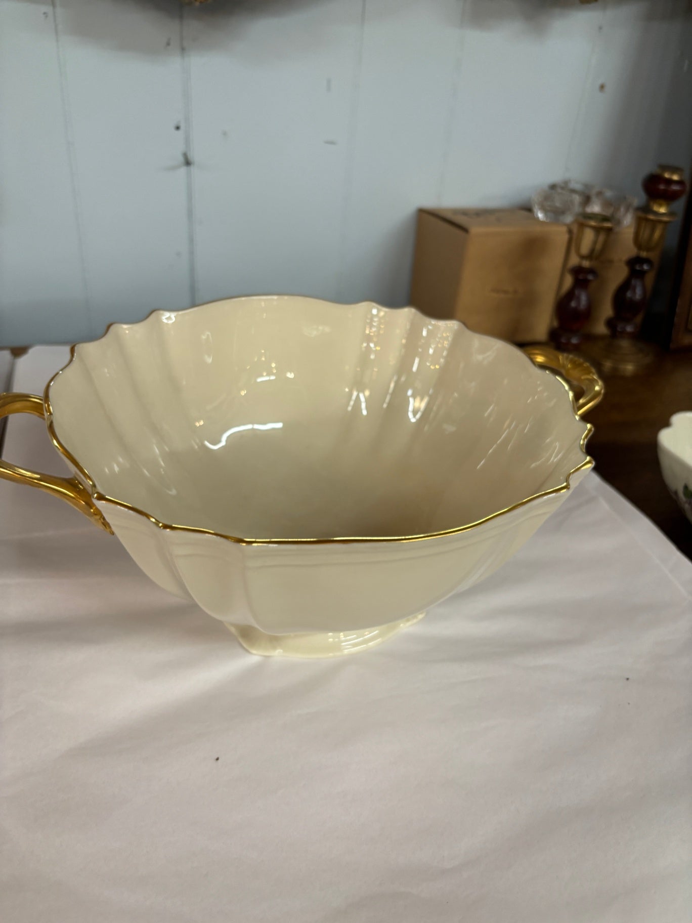 Lenox Symphony serving bowl is crafted from off-white porcelain and detailed with 24k gold trim and handles