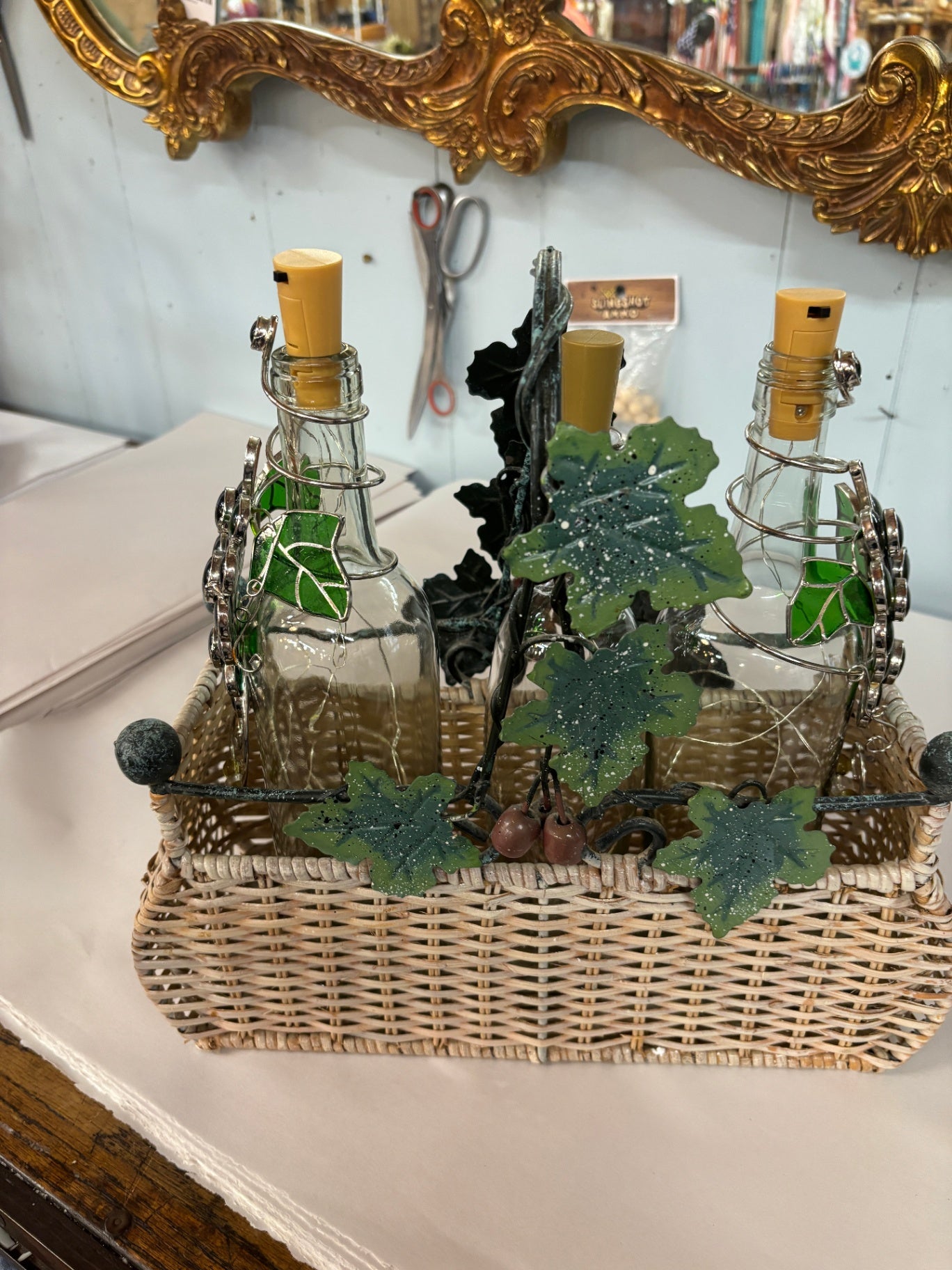 Wicker and brass wine bottle caddy With Lighted Bottles