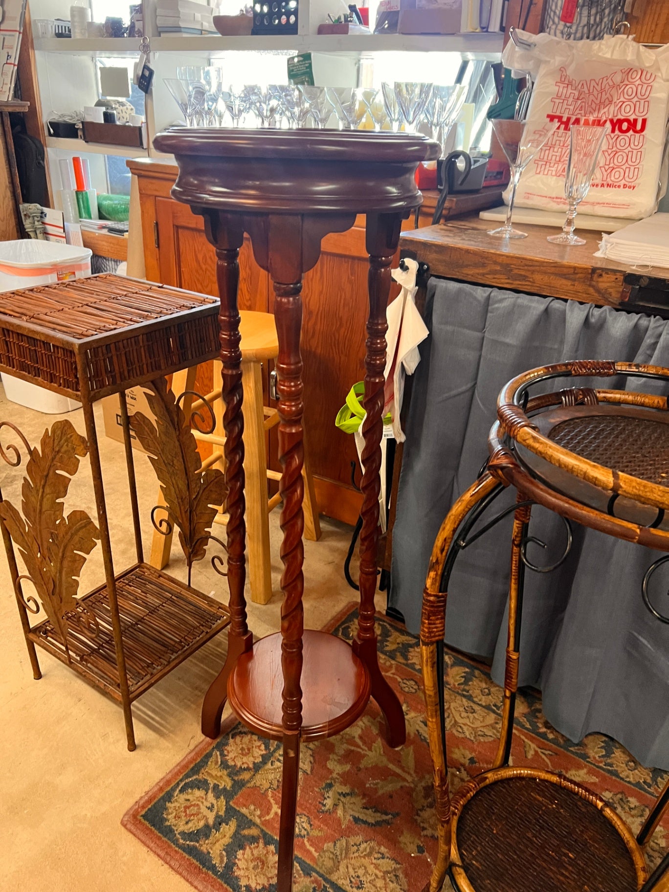 This is an antique wooden barley twist plant stand or pedestal table.