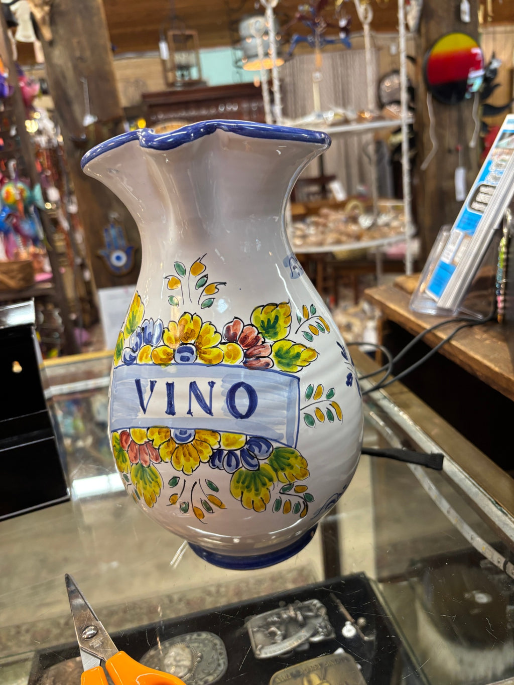 Hand-painted Italian Deruta ceramic "Vino" pitcher featuring vibrant yellow and blue floral and fruit motifs