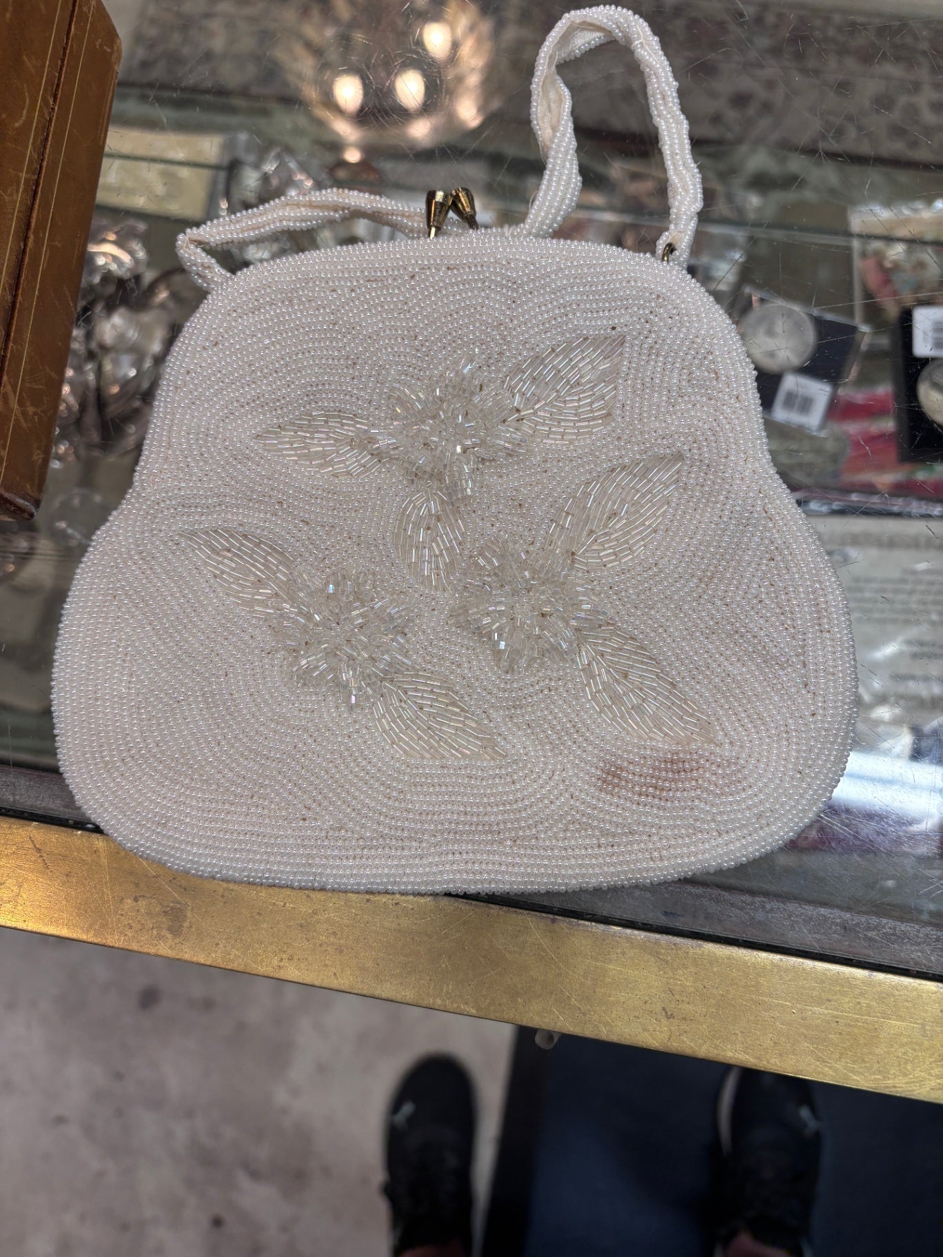 Vintage white beaded evening handbag featuring an intricate floral and leaf beadwork