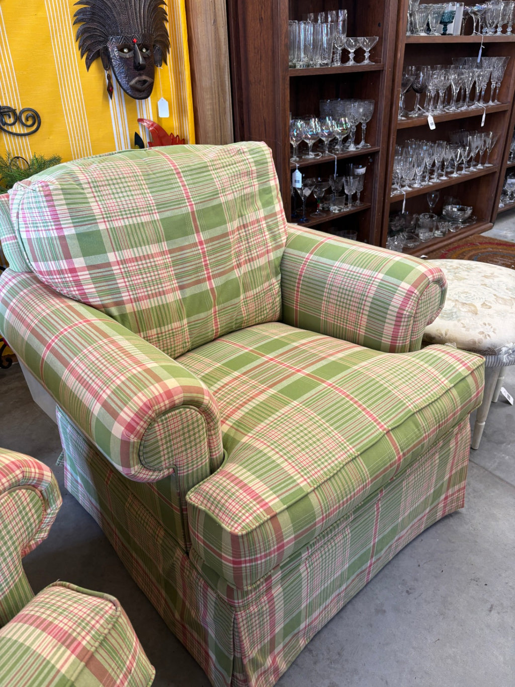 Vintage upholstered armchair featuring a classic green, pink, and white plaid or tartan pattern with rolled arms and a skirted base