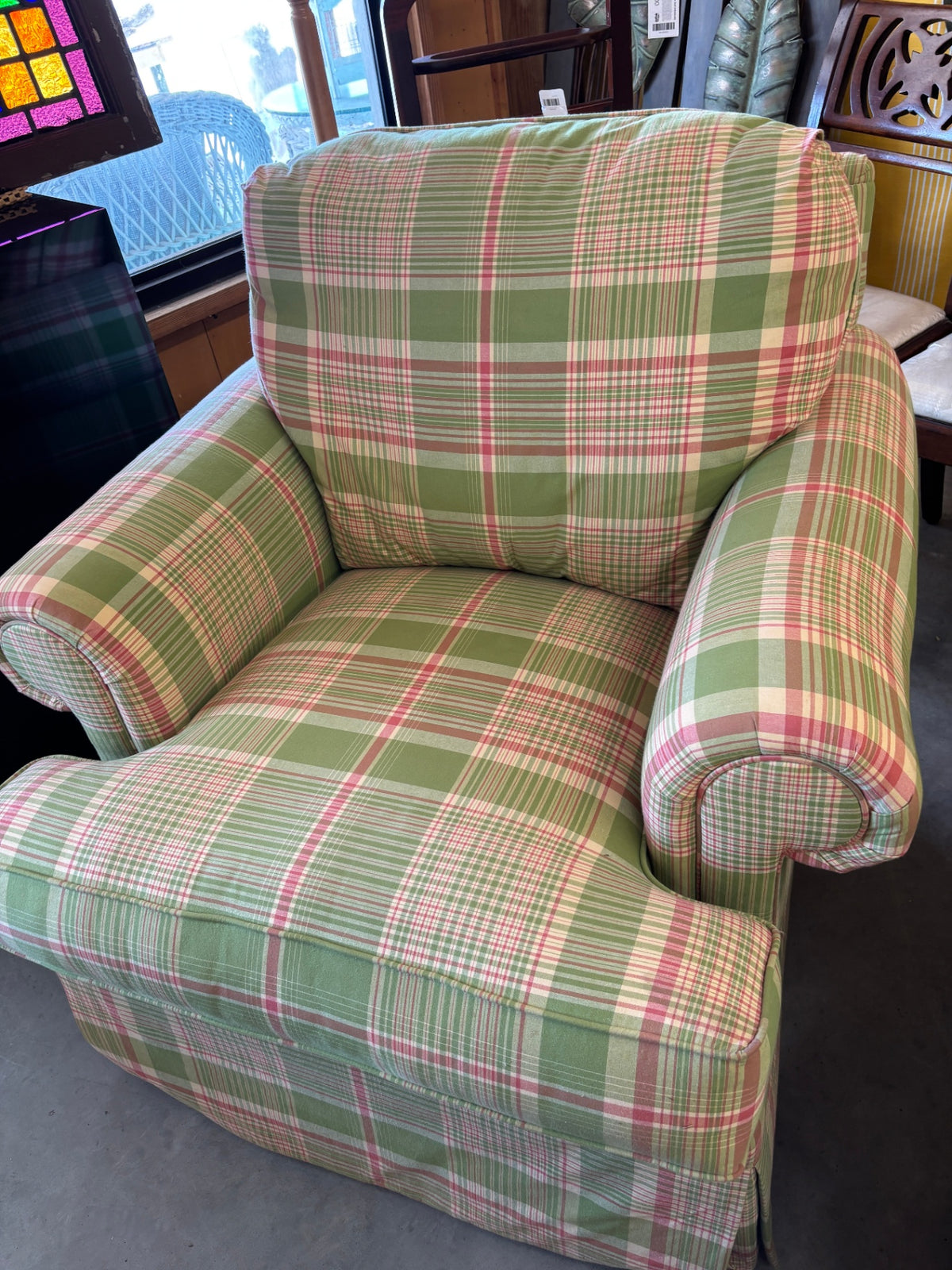 Vintage upholstered armchair featuring a classic green, pink, and white plaid or tartan pattern with rolled arms and a skirted base