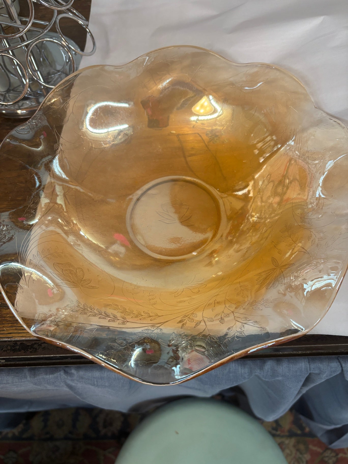 Marigold carnival glass ruffled bowl featuring an iridescent amber finish