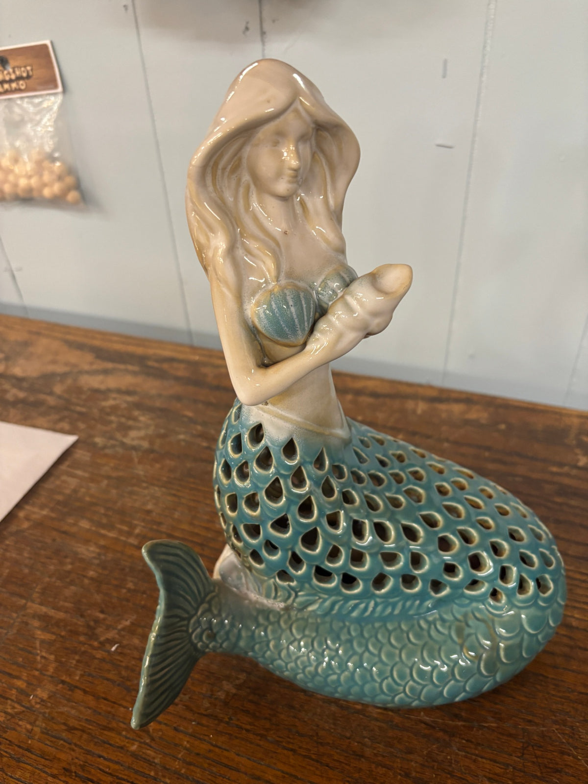 Coastal Ceramic Mermaid Figurine with Shell – Teal Openwork Tail