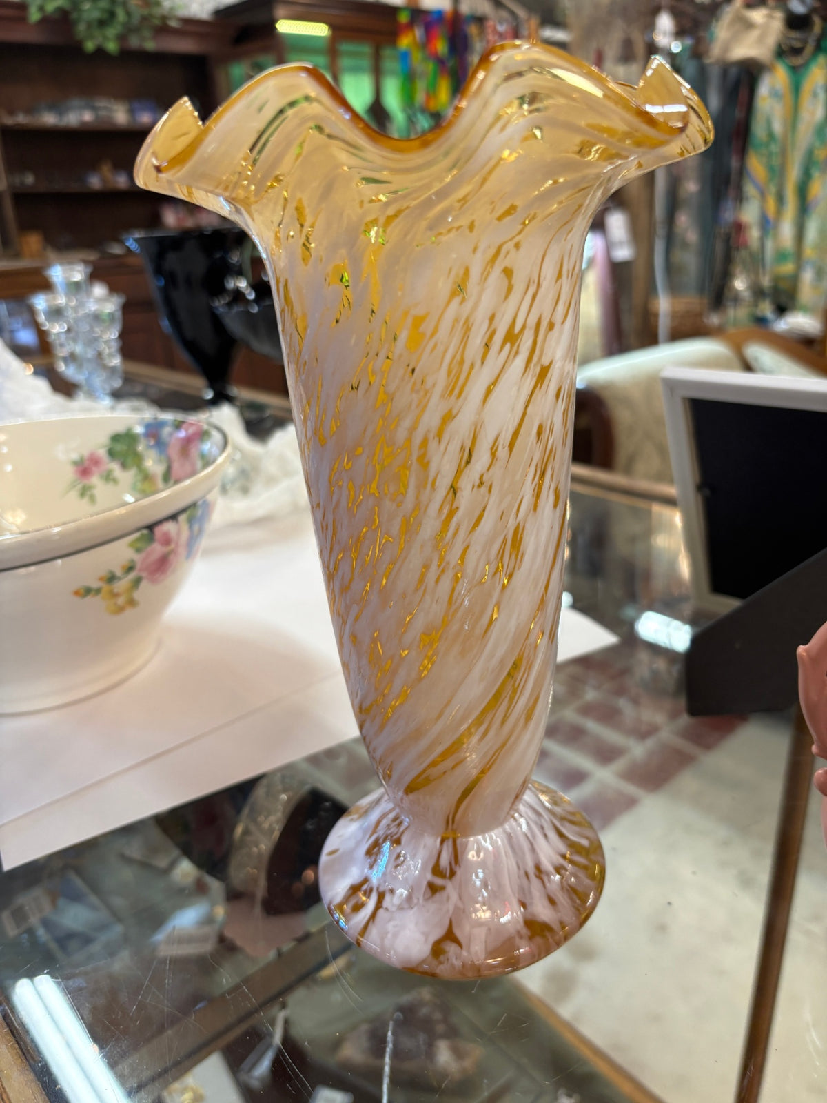 Handblown art glass vase featuring a ruffled flared rim and a white and amber-gold swirled or splatter pattern