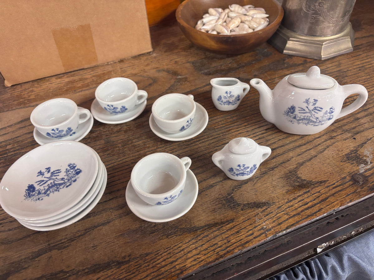 Vintage miniature ceramic tea set featuring a blue and white Asian landscape