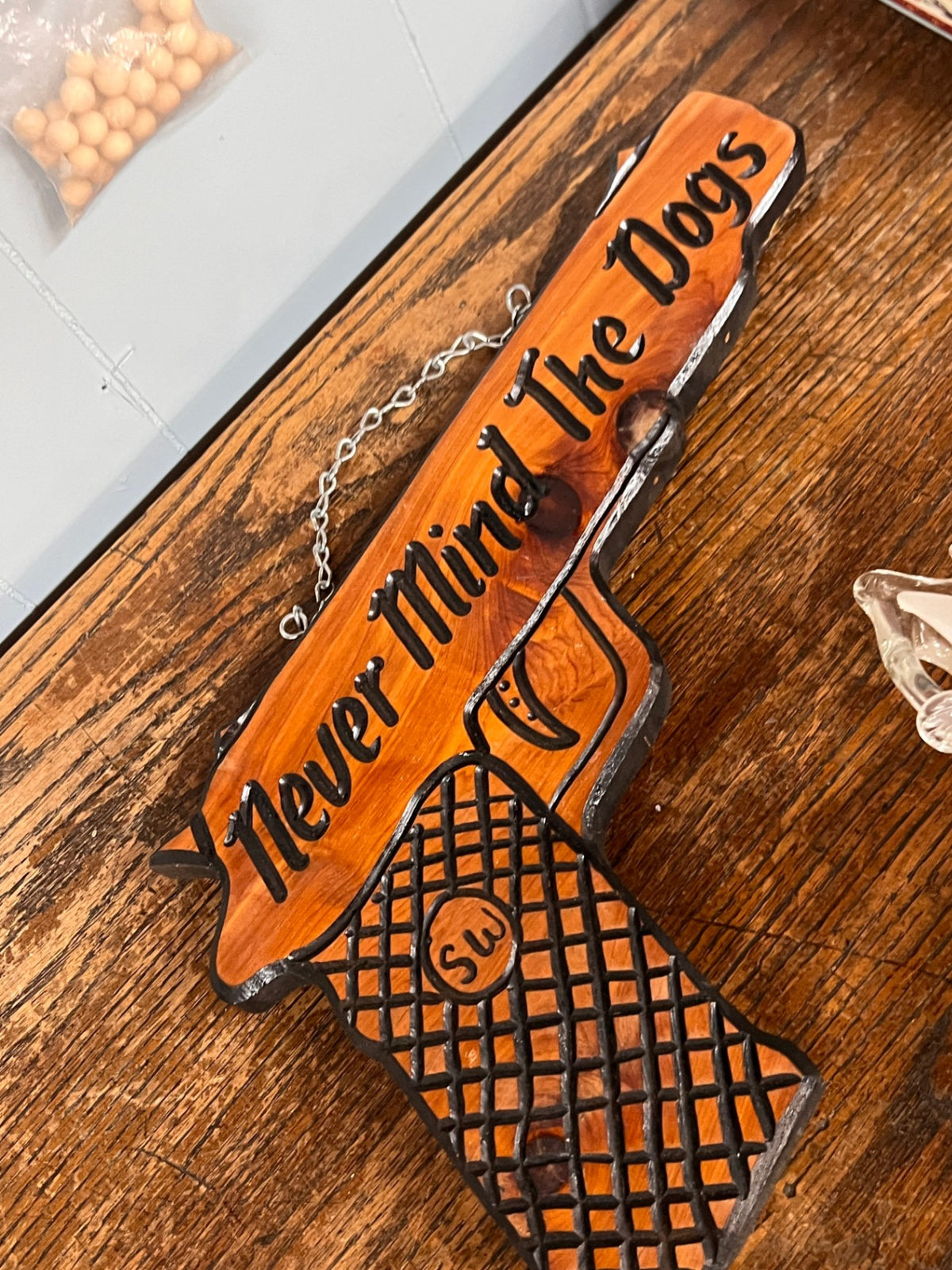 Rustic Handcrafted Wooden “Never Mind The Dogs” Gun-Shaped Wall Sign – 14"