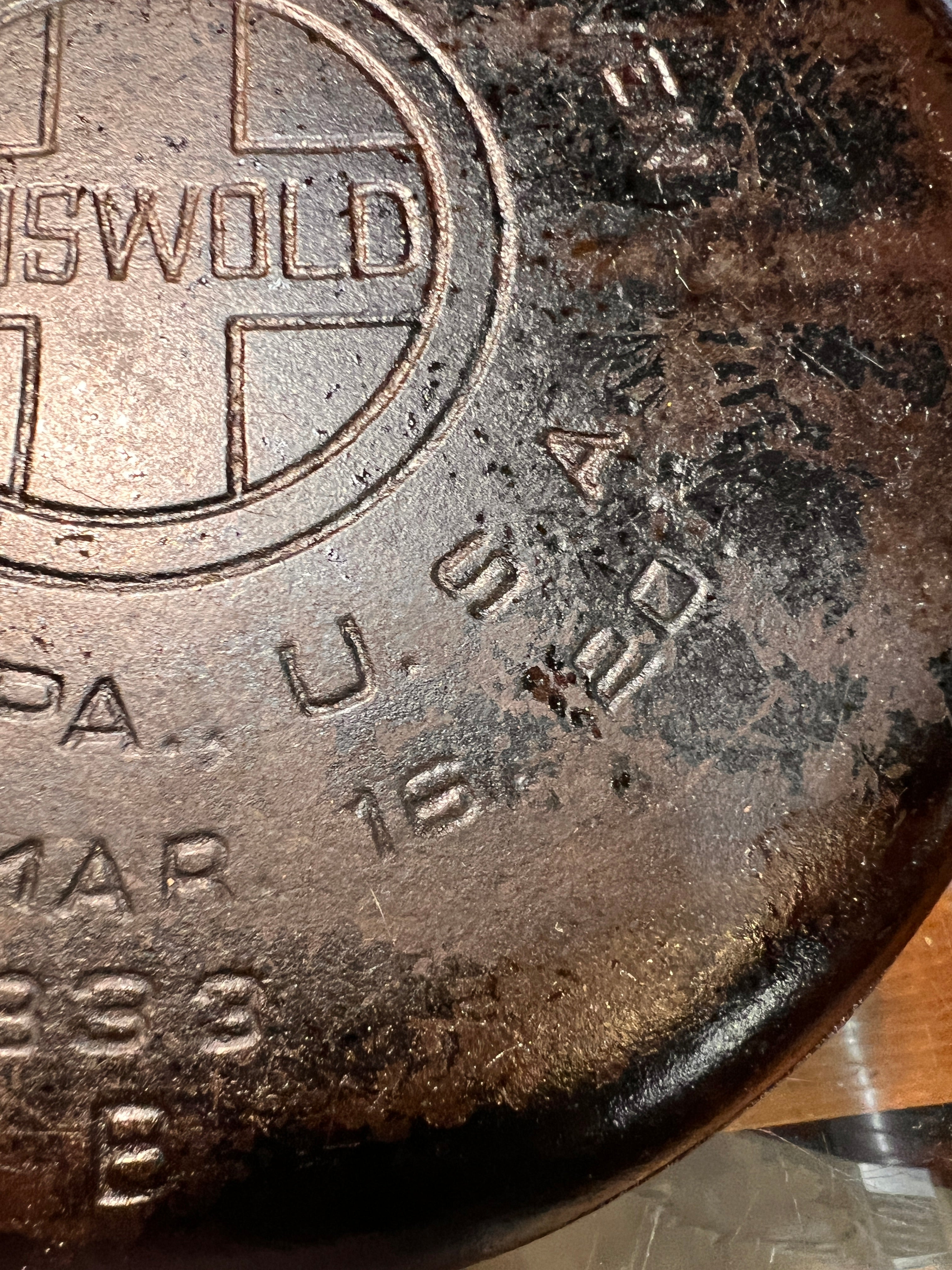 Close-up of a cast iron skillet with branding and text.