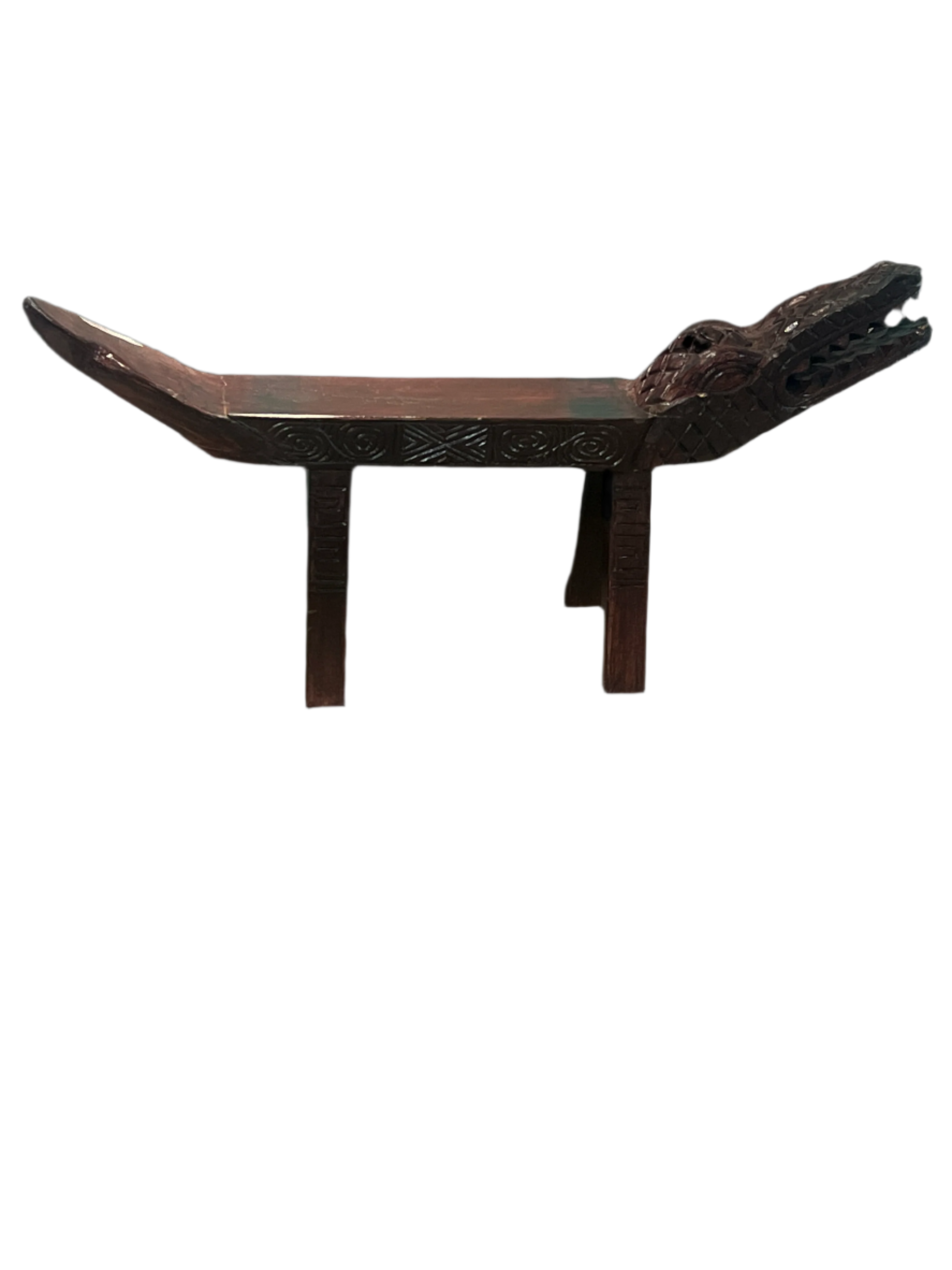 Bronze or copper-colored metal object with a curved top and two vertical supports on a black background