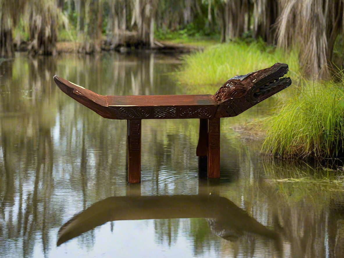Wooden bench in a natural setting with water and greenery