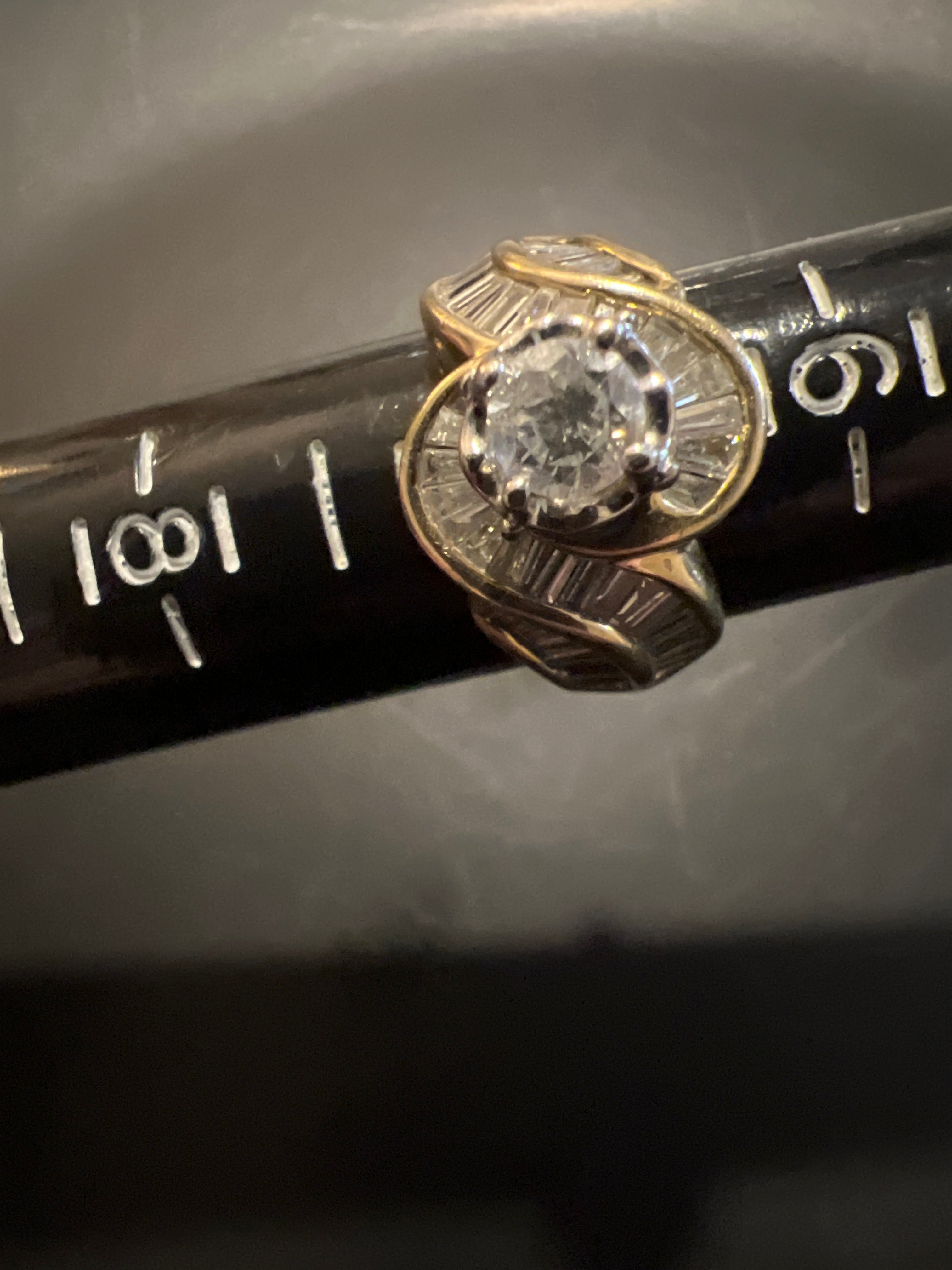 Size 7 ladies ring 14 karat gold 1.5 Carat center diamond plus baguettes.