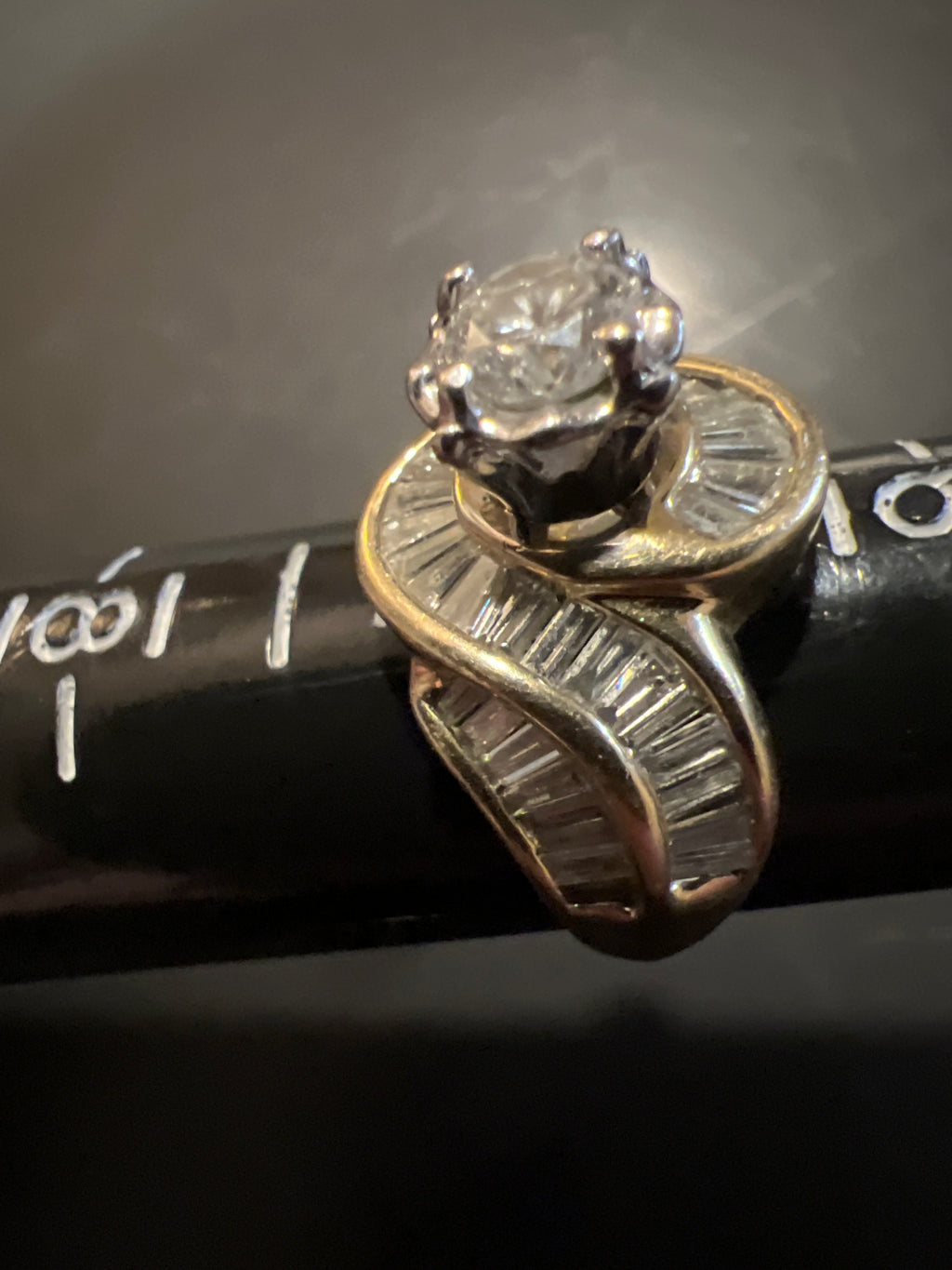 Size 7 ladies ring 14 karat gold 1.5 Carat center diamond plus baguettes.