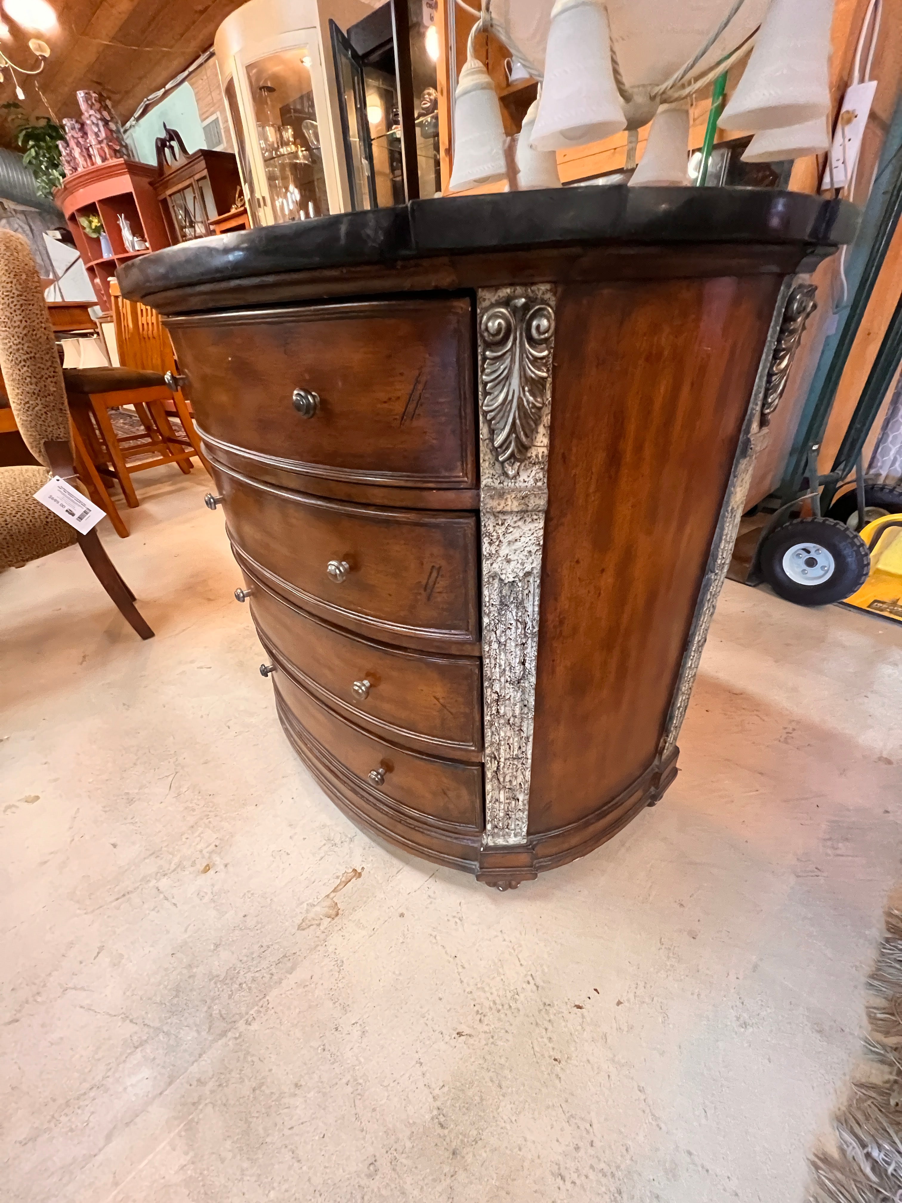 Wooden dresser with decorative elements on a beige floor