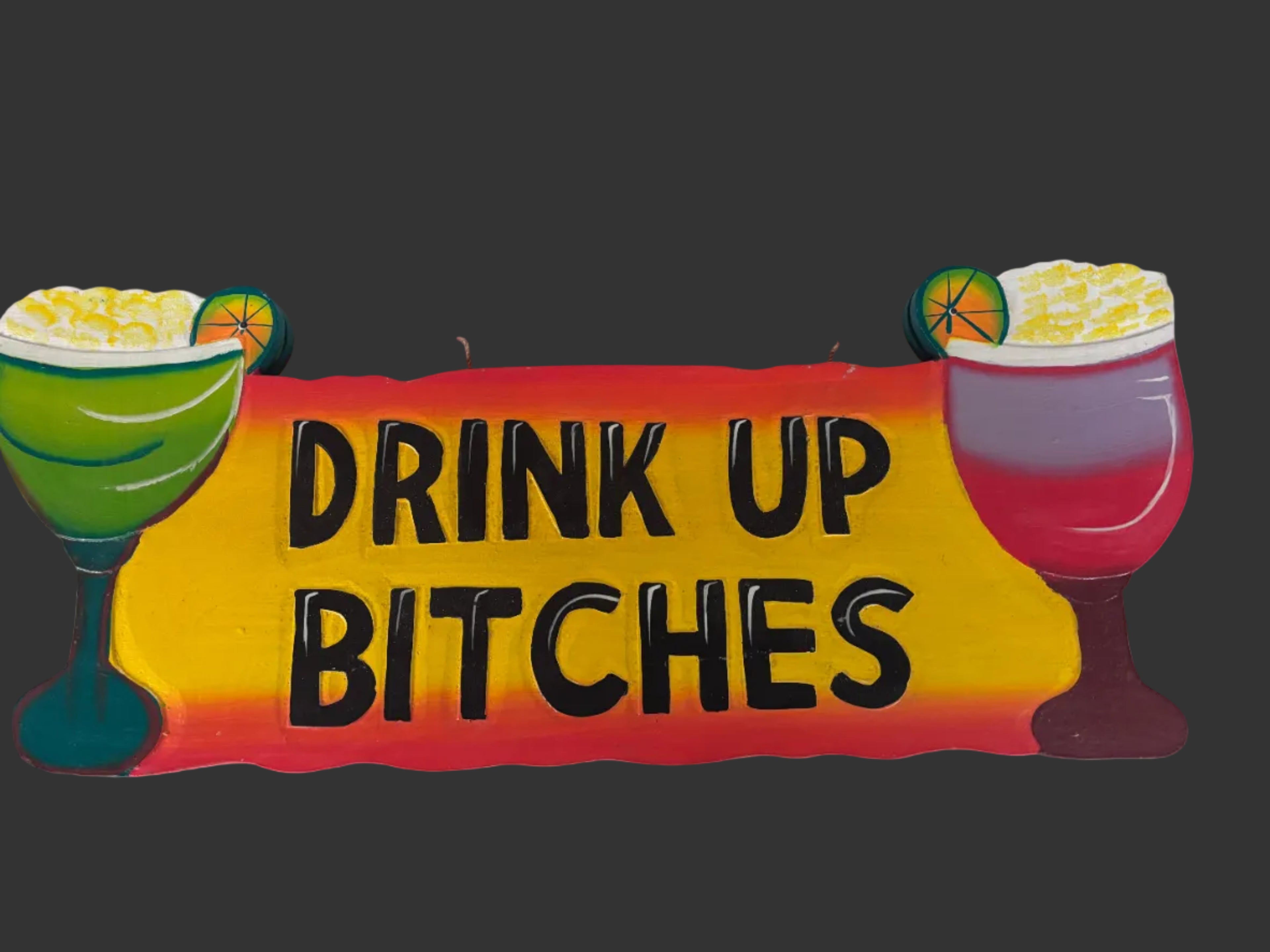A novelty wooden sign with the text 'DRINK UP BITCHES' in bold black letters on a yellow and red gradient background, flanked by two cocktail illustrations on the sides.