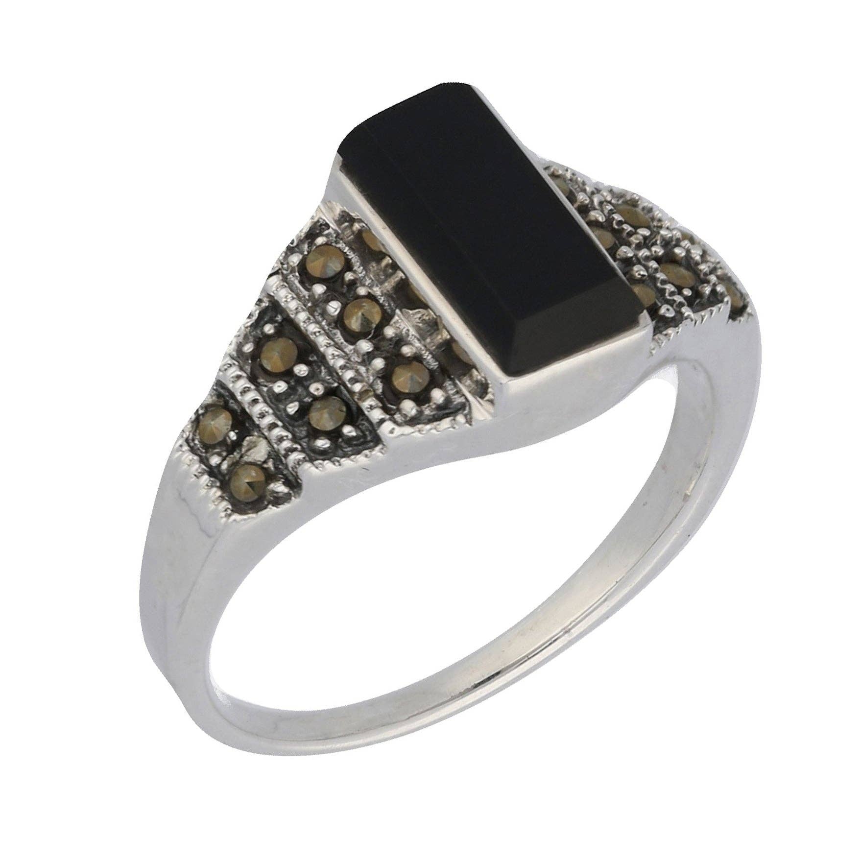Silver ring with black stone and smaller brown stones on a white background